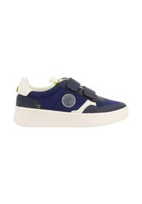 Zapatilla de deporte azul marino con detalles en blanco, parte superior de textil, tiras de Velcro, parche con el logo y suela de goma texturizada. Diseño ligero y deportivo.