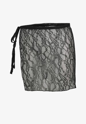 Mustast pitsist ümbermähkimisega seelik lillemustriga, vasakul küljel paelaga seotud, läbipaistev kangas ja sirge lõige.