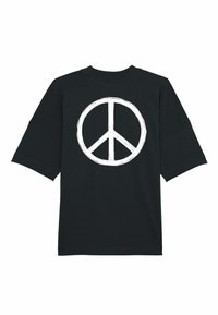 Svart kortärmad T-shirt med en stor vit fredssymbol tryckt på ryggen. Har rund nacke och avslappnad passform.