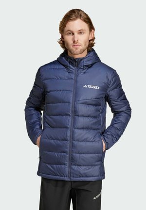 Navy blue puffer jacket with a hood, featuring horizontal quilted sections, zip front closure, and "TERREX" logo on the left chest.