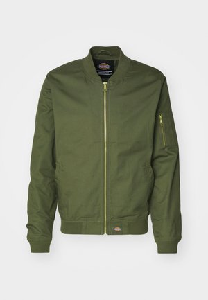Olive green bomber jacket with a zip front, ribbed cuffs, and hem. Features a zip pocket on the left sleeve and logo patch at the waist.
