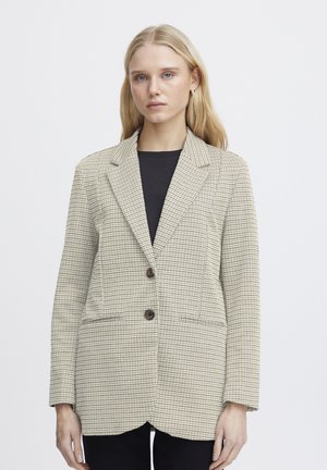 Béžový kostkovaný blazer s dvěma předními knoflíky, strukturovanými klopami a bočními kapsami. Měkký textilní vzhled, rukávy střední délky, propracovaný střih.