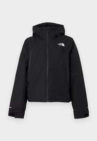 Veste isolante noire avec capuche, fermeture éclair frontale complète, deux poches poitrine zippées et logo The North Face sur la partie supérieure gauche de la poitrine.
