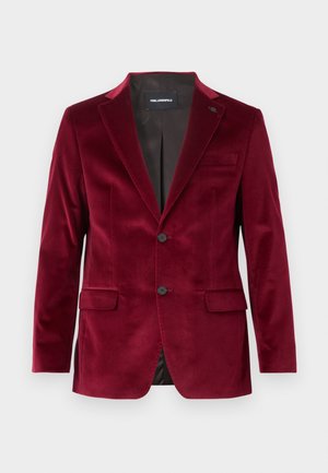 Blazer da uomo su misura in velluto color bordeaux con rever a incavo, chiusura frontale con due bottoni, tasche con patta e fodera interna nera.