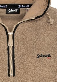 Beige Fleece-Halbzip-Pullover mit schwarzem Besatz, der ein auffälliges Markenlogo und ein strukturiertes Gewebe für zusätzliche Wärme aufweist. Silberner Reißverschluss.