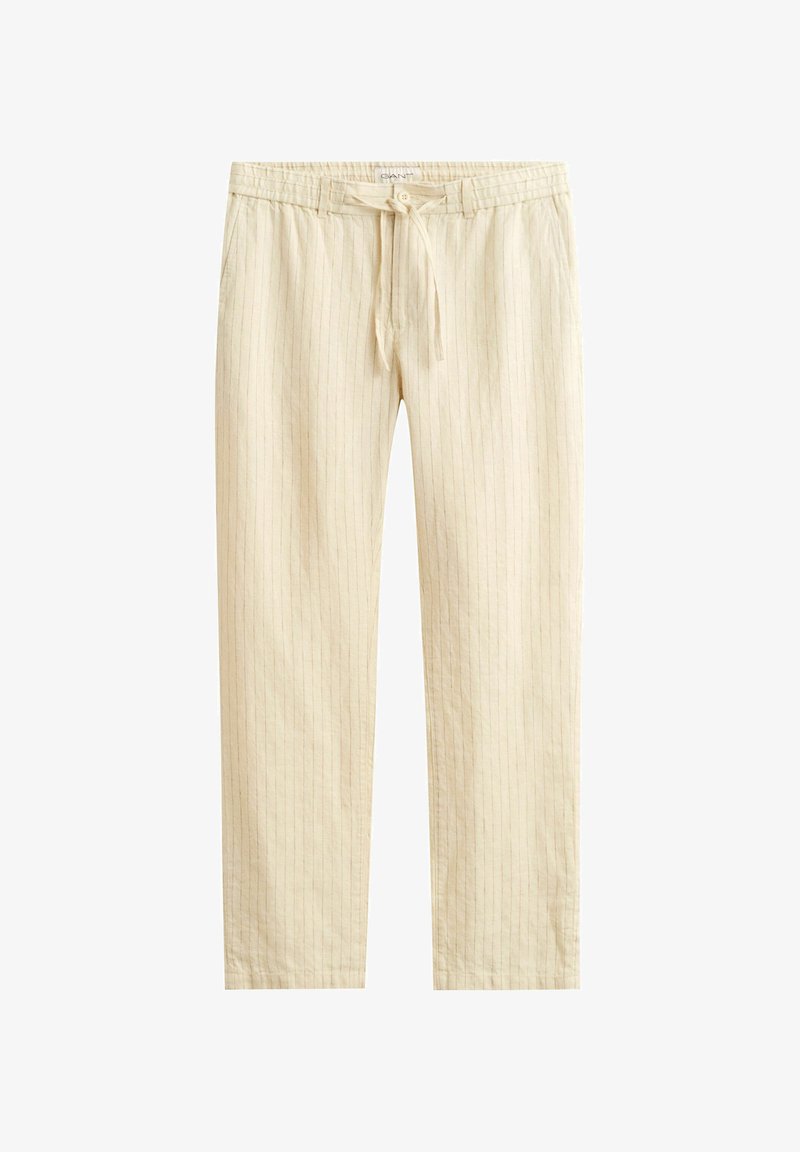Pantalones beige con cordón, con sutiles rayas verticales, cintura elástica, bolsillos laterales y corte recto.