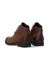 Braune Lederstiefeletten mit einer abgerundeten Spitze, Schnürung vorne und einem Reißverschluss an der Seite. Gestapelter Absatz und glatte, matte Oberfläche.