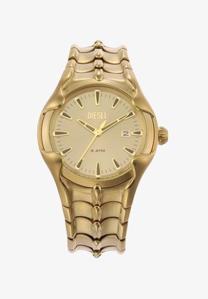 Montre Diesel dorée avec un cadran rond, un visage texturé beige, des index horaires audacieux et un bracelet métallique en maillons épais.