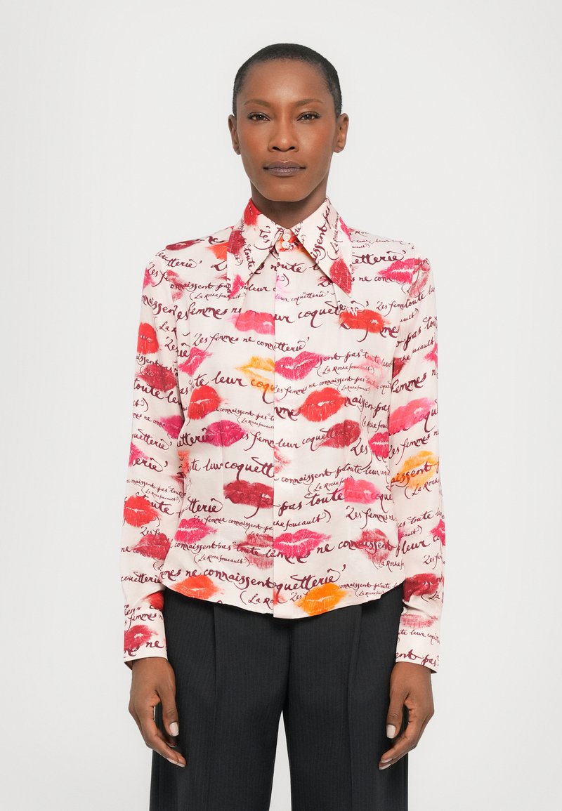 Long-sleeve shirt in lightweight fabric featuring a pattern of colorful lip prints and handwritten text on a white background.