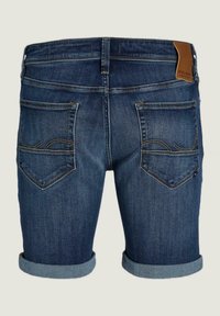 Shorts de mezclilla en azul oscuro con una textura ligeramente desgastada, puños enrollados y dos bolsillos traseros con detalles de costura amarilla.