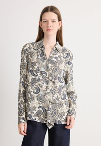 Long-sleeve blouse in cream with blue and gold paisley pattern. Features a button-down front and soft fabric with a relaxed fit.