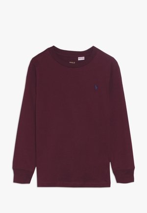 Langærmet bluse med rund hals i mørk burgunder med et lille marineblåt broderet logo på venstre bryst.