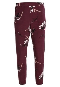 Pantalones burdeos con un estampado floral en blanco y negro. Tejido ligero con un corte ajustado y cinturilla elástica.