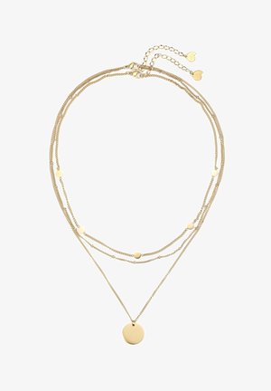 Collier superposé en or avec plusieurs chaînes fines, petits disques circulaires sur les chaînes supérieures, et un pendentif rond plus grand sur la chaîne la plus longue.