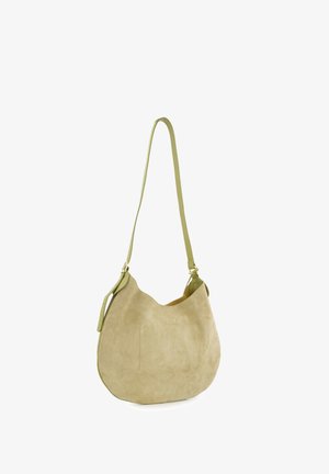 Green suede shoulder bag with a curved shape, leather strap, and a small exterior pocket. Soft texture and a minimalist design.