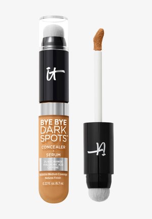 Sérum anti-cernes avec applicateur brosse intégré, étiqueté "Bye Bye Taches Sombres", avec des ingrédients et un ton moyen.