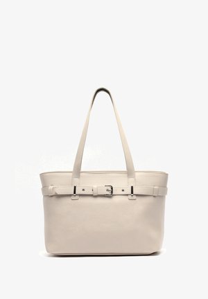 Beige leather tote bag with two long handles, a smooth texture, a structured shape, and a buckle accent on the front.