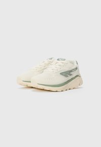 Off-white and light green athletic sneakers with textured soles, lace-up closure, and mesh and suede fabric panels.