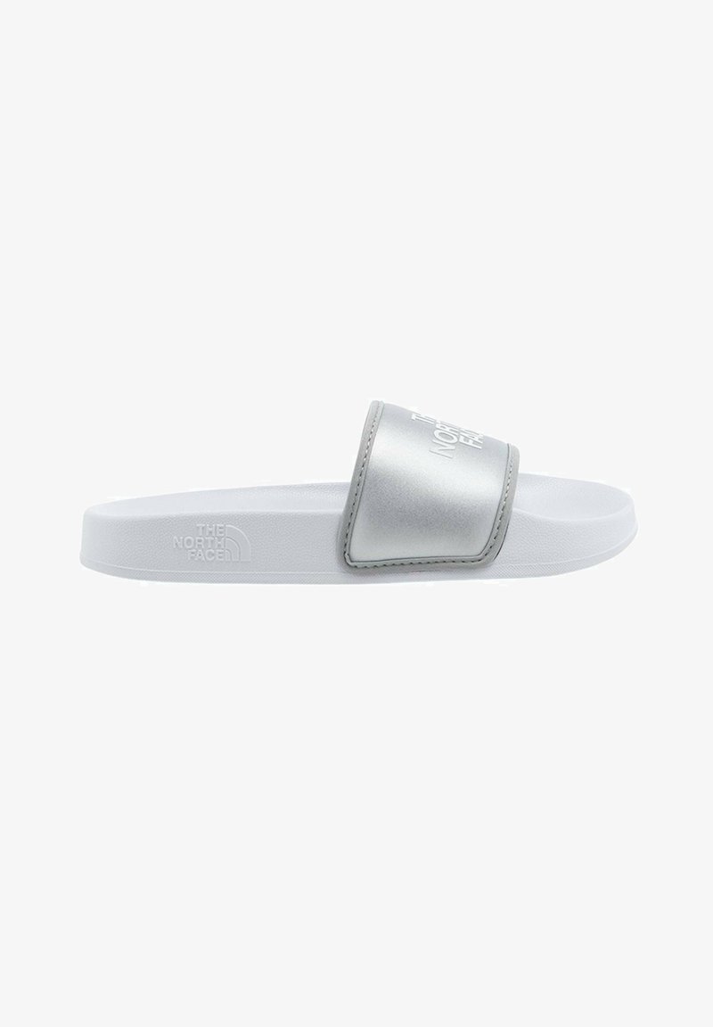 Silver slide sandal featuring a padded strap with embossed logo, a textured white footbed, and a sturdy white outsole.