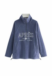 Fleece pullover in dark blue with high collar and zip. Features front pocket, white graphic text “APRÈS”, and contrasting zipper details.