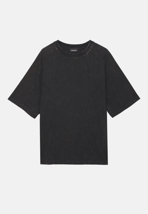 T-shirt noir à manches courtes avec col rond, détails de coutures visibles et texture légèrement décolorée, posé à plat sur un fond blanc.