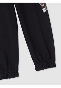 Czarne dresy z elastycznymi mankietami i częściowym grafiką psa w butach na górnej części nogawki.