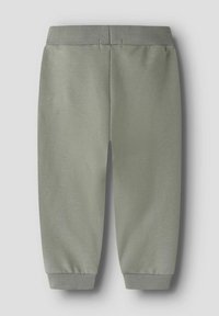Pantalon de jogging vert clair avec une texture douce en coton, doté d'une taille et de poignets élastiqués, au design simple sans motifs.