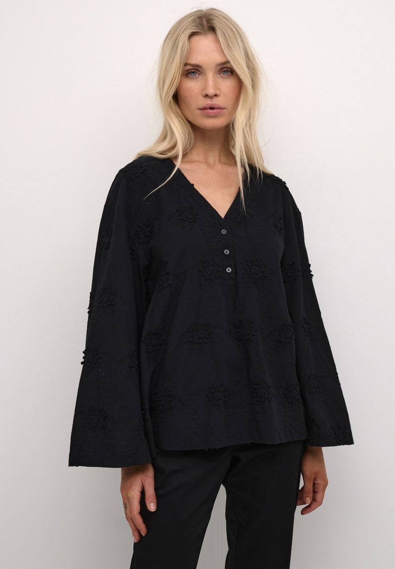 Blusa nera ricamata con scollatura a V, chiusura frontale a bottoni e maniche a campana con motivi floreali testurizzati.