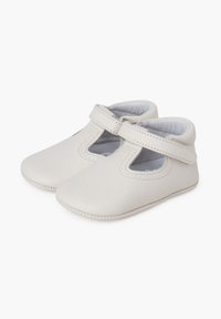 Zapatos de bebé en suave cuero blanco con diseño de tirante en T, que cuentan con un interior acolchado y costuras en contraste en los bordes.