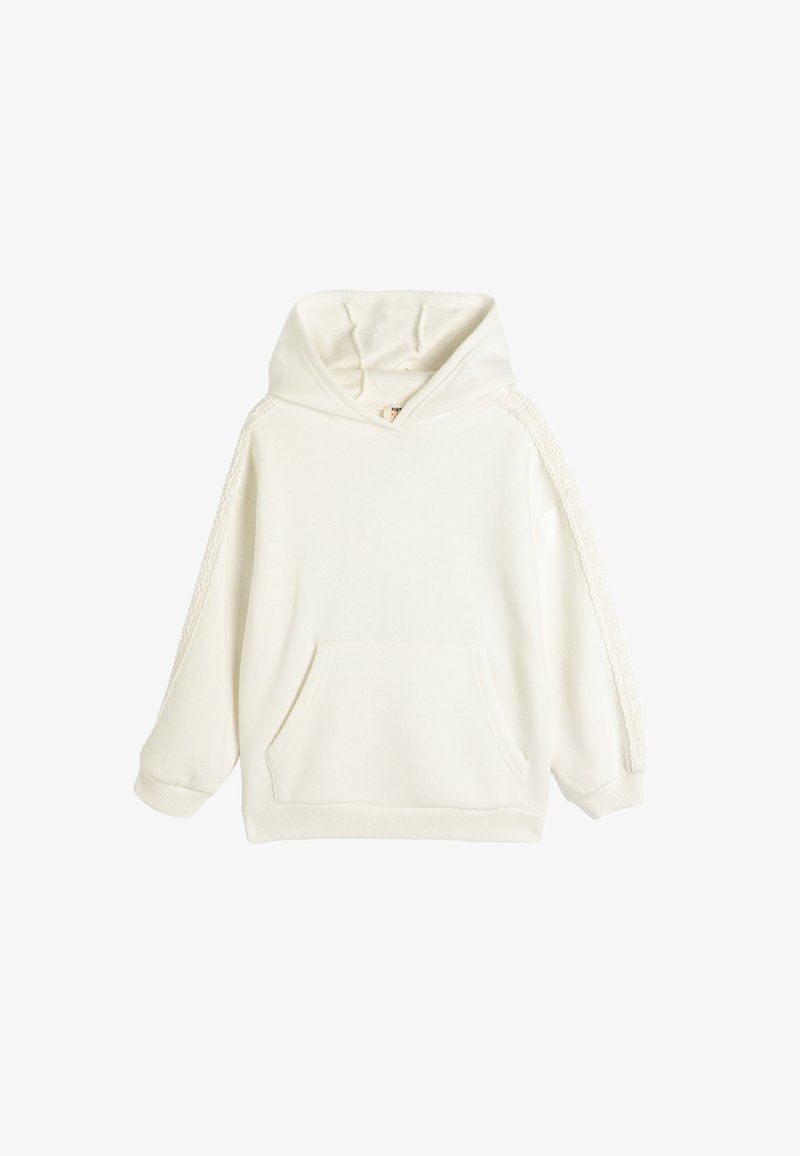 Biały hoodie z kieszenią z przodu, długimi rękawami i koronkowymi detalami na ramionach. Wykonany z miękkiego materiału o luźnym kroju.