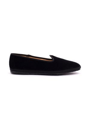 Black velvet slip-on flat shoe with rounded toe and low rubber sole shown from the side on a white background.