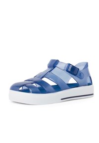 Translucent navy blue plastic sandals with crisscross straps, adjustable buckle closure, and white rubber sole with a black accent line.