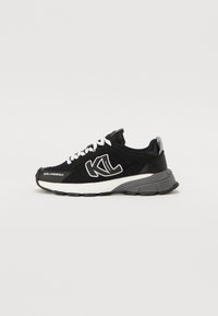 Black athletic sneakers with a breathable mesh upper, white laces, and logo detail. Features a grey cushioned sole and black accents.