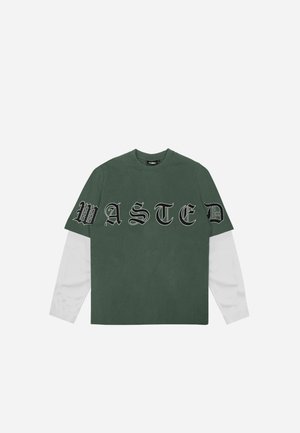 Green short-sleeve t-shirt featuring "WASTED" in bold black script across the front with white long sleeves extending from the bottom.