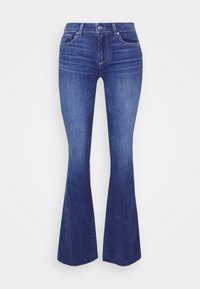 Tummansinisiä levenevät farkut, valmistettu denimistä. Ominaisuuksiin kuuluu keskikorkea vyötärö, viisi taskua ja hillitty haalistuminen lahkeilla.