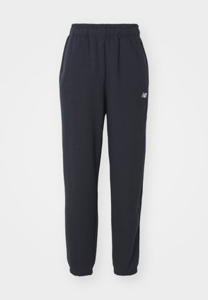 Black sweatpants with an elastic waistband, two side pockets, and a small white logo on the left hip. Made of soft fabric with a smooth texture.