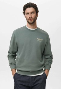 Green cotton sweatshirt with ribbed cuffs and hem, featuring a white inner collar, and a gold text logo on the chest.