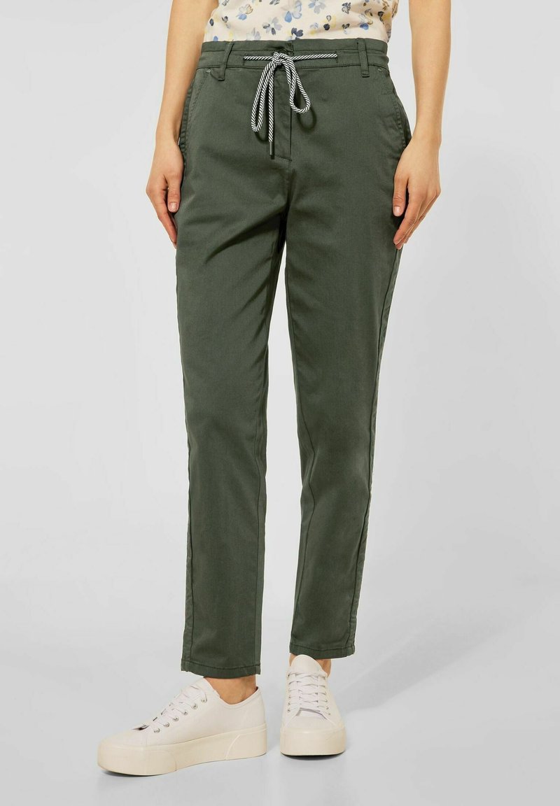 Khaki green casual pants with a drawstring waistband and side pockets, featuring a slim fit and lightweight fabric, paired with white sneakers.