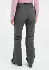 Gray ski pants made of waterproof material, featuring a high waistband, wide legs, and zippered vents at the ankles. Suitable for winter sports.