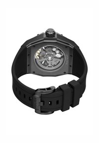 Črna osmerokotna ura z ohišjem iz nerjavečega jekla, prozornim številčnico, ki prikazuje zobnike, ter črnim gumijastim paščkom z zaponko.