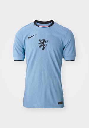 Light blue Nike football jersey with short sleeves, ribbed texture, black lion emblem at center, and black collar accents.