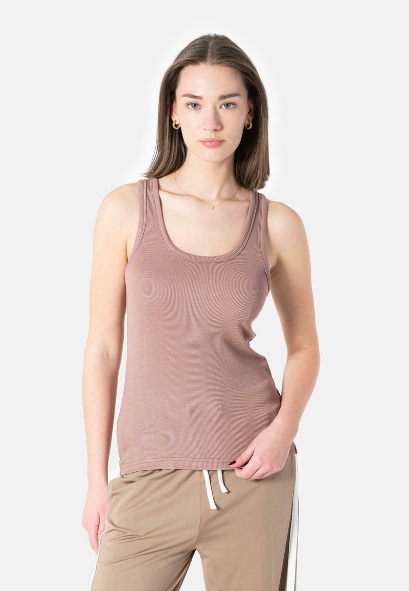 Light brown ribbed tank top with a rounded neckline and wide shoulder straps, paired with beige joggers featuring white side stripes.