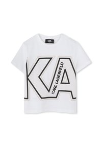 T-shirt cropped en coton blanc avec un grand logo "KA" noir et doré, comprenant des lignes diagonales, des manches courtes et un col rond.