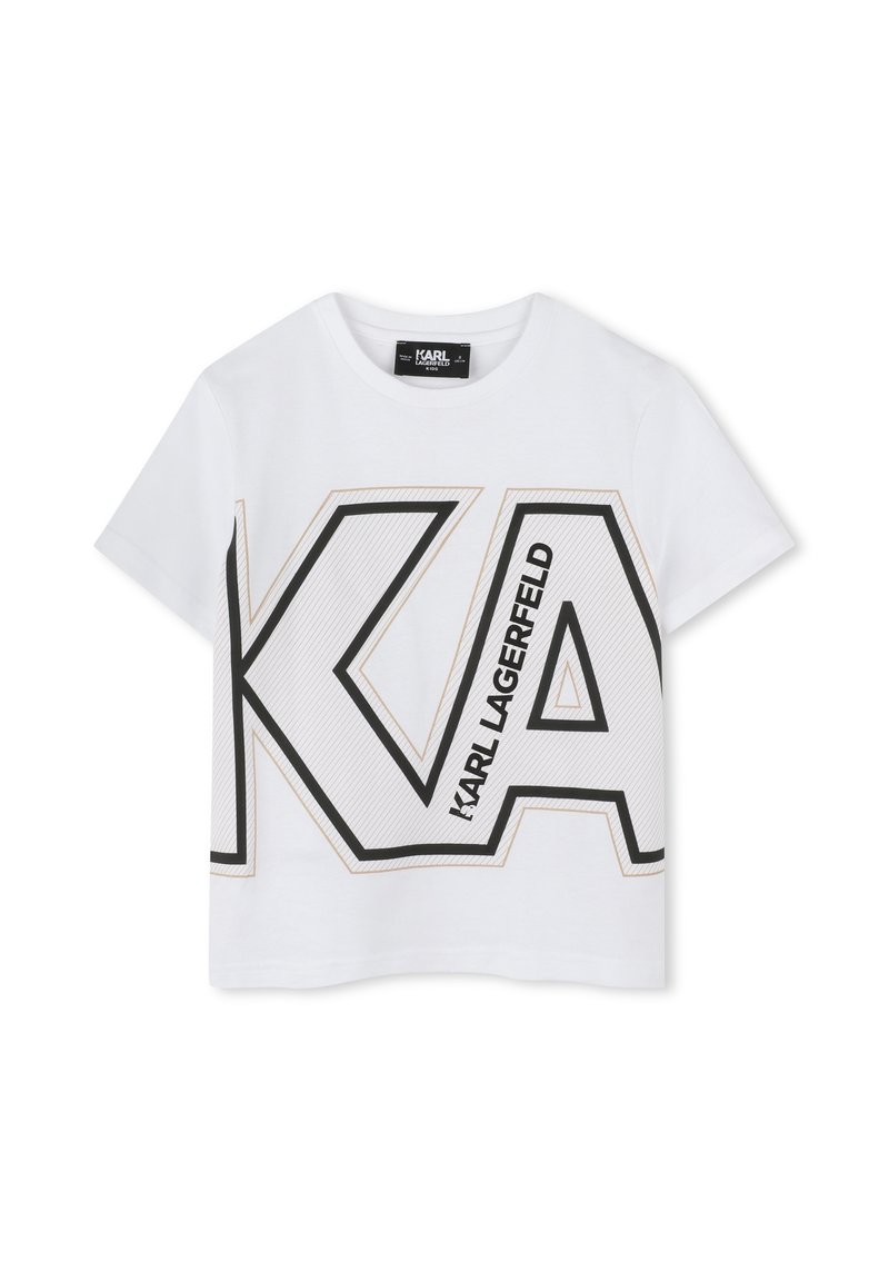 T-shirt cropped en coton blanc avec un grand logo "KA" noir et doré, comprenant des lignes diagonales, des manches courtes et un col rond.