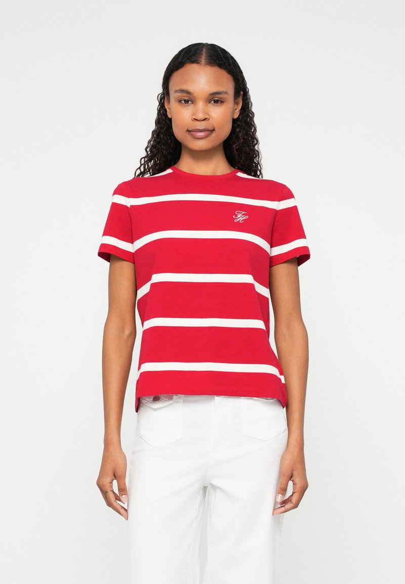 Red striped t-shirt made of cotton, featuring white horizontal stripes, short sleeves, and a rounded neckline, with a small logo on the chest.