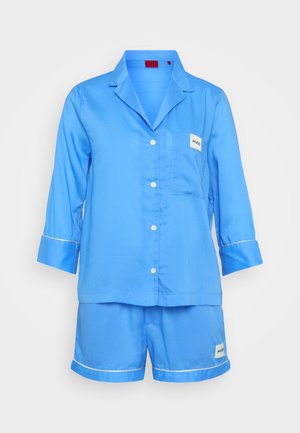 Blue short-sleeve pajama set made of smooth fabric, featuring a notched collar, chest pocket, and white piping on sleeves and shorts.