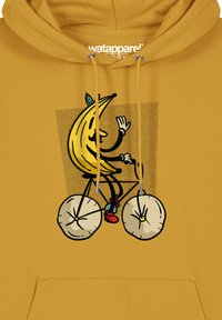 Gelbe Kapuzenjacke mit einem grafischen Motiv eines Bananencharakters, der auf einem Fahrrad mit runden, weißen Rädern fährt, umgeben von einem verspielten Design auf einem gepunkteten Hintergrund.