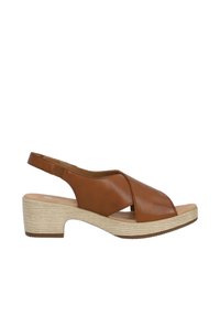 Brown leather slingback sandal with an open toe, cross strap design, and a stacked heel. Textured, light-colored sole.