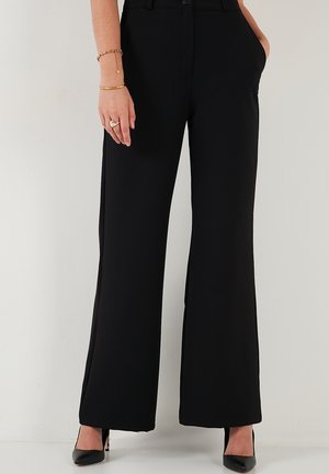 Black wide-leg trousers made of smooth fabric with front pockets, featuring a fitted waistband and a button closure at the front.