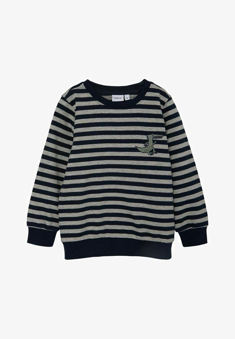 Sweatshirt rayé en navy et gris. Matière douce avec des manches longues, des poignets côtelés et un petit motif vert brodé sur la poitrine.